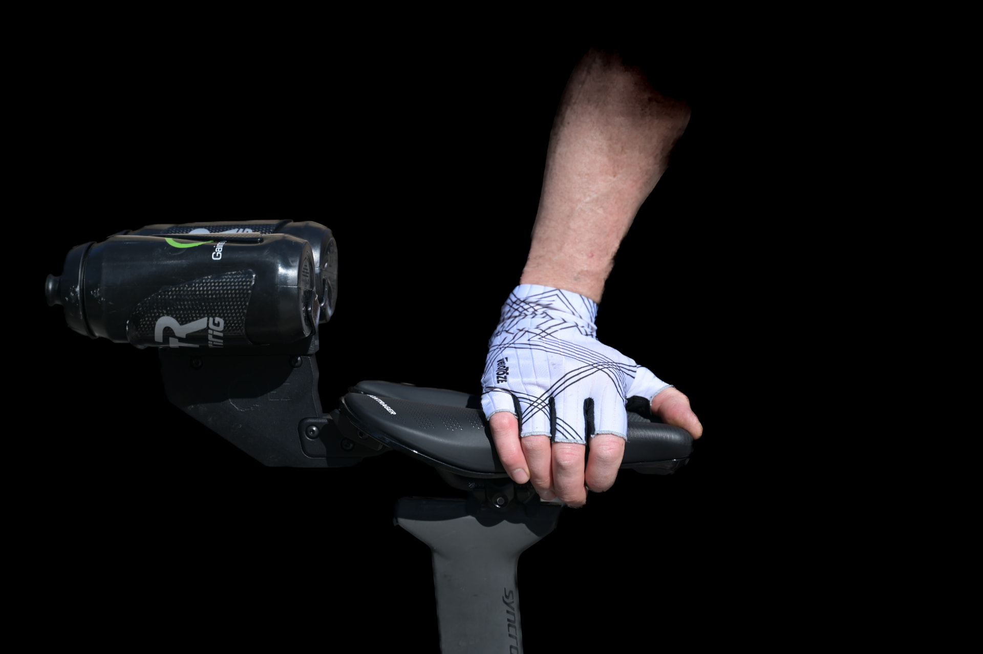 Rider's gloved hand on the saddle against a black background