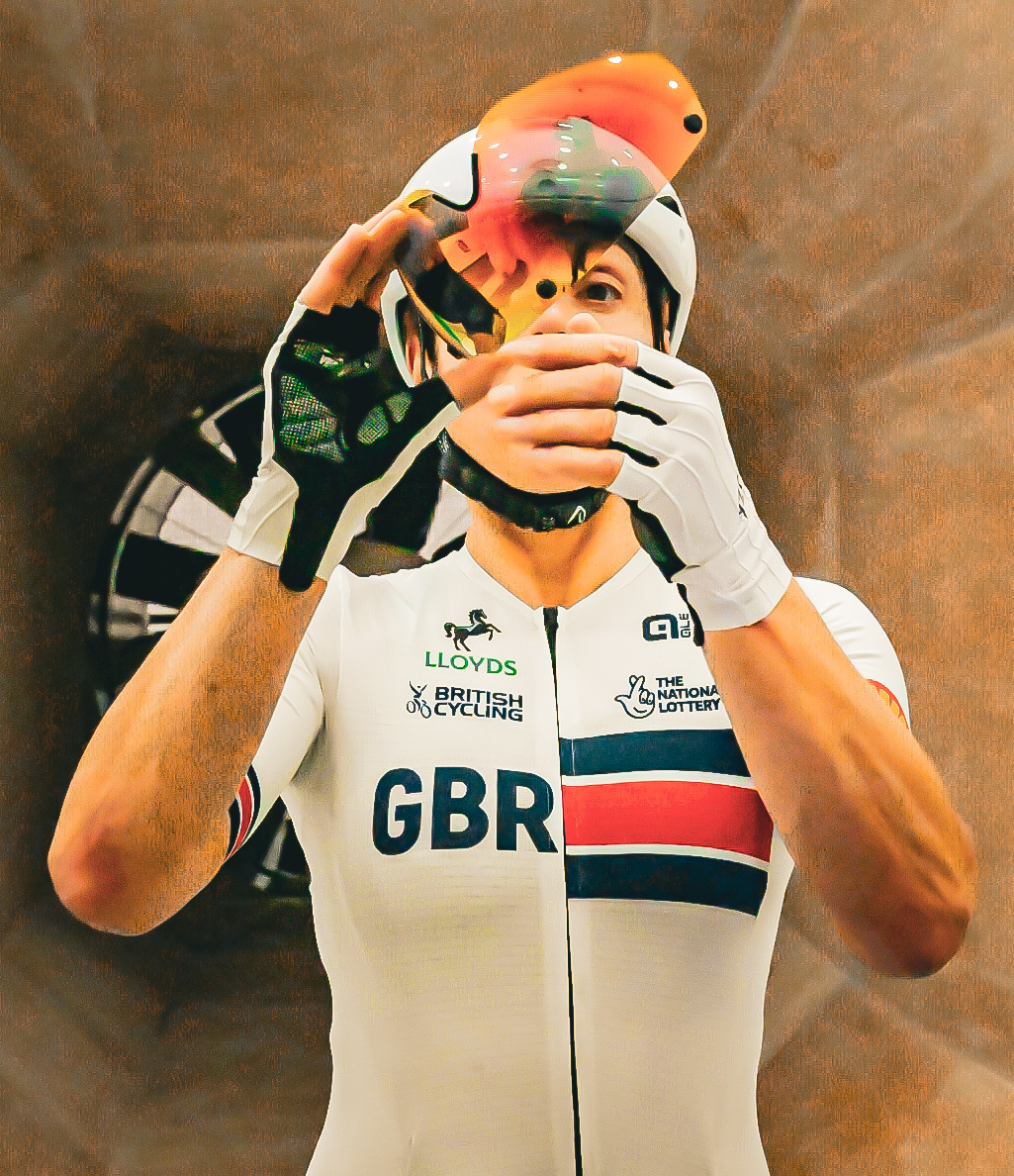 Great Britain track cyclist adjusting a visor before racing