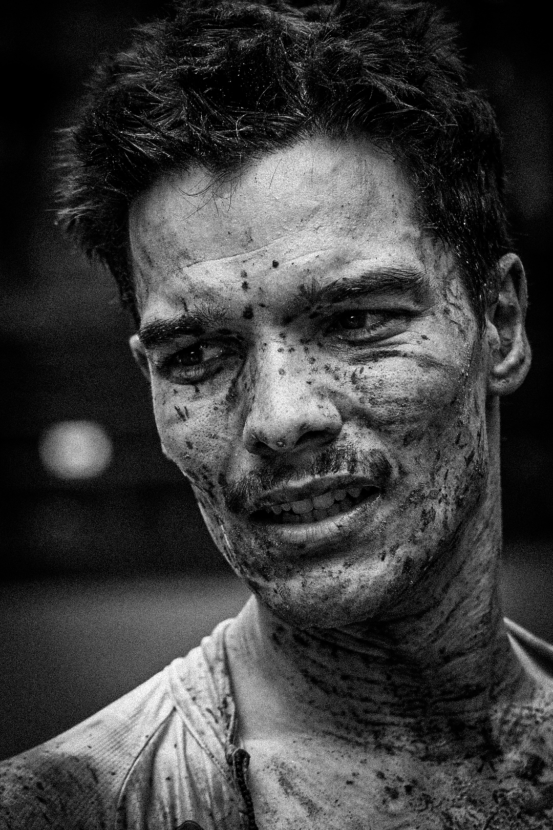 Mud covered athlete portrait after an obstacle race